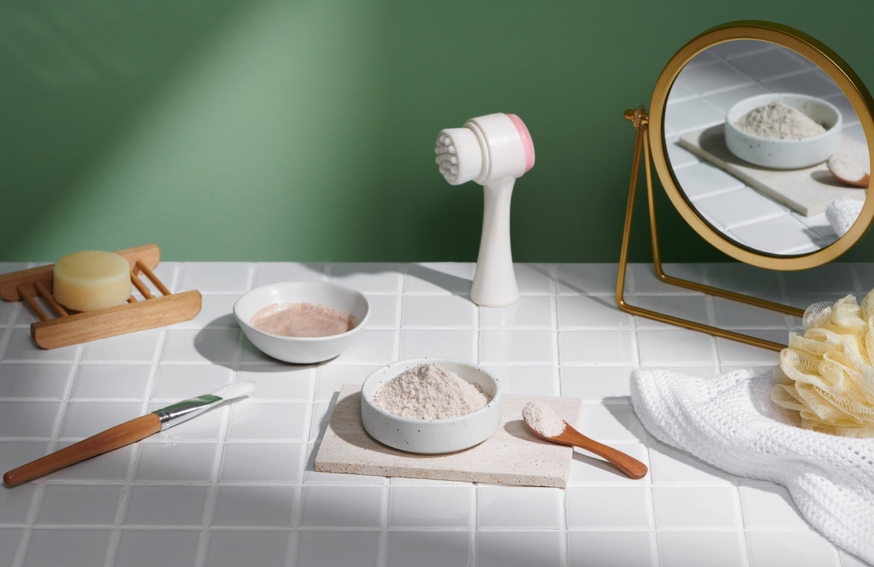 Bathroom tile with powders, soaps, mirrors and a face brush