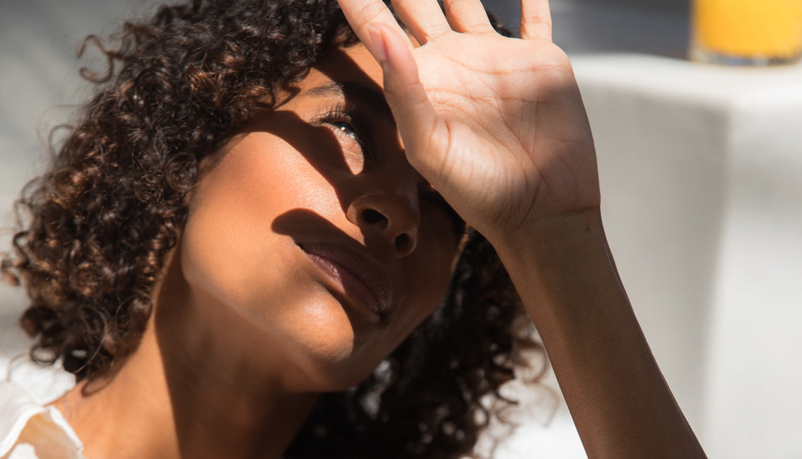 Woman shielding her face from the sun