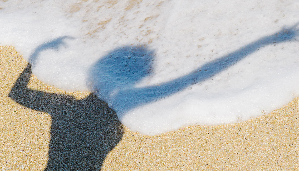 Shadow of person on beach