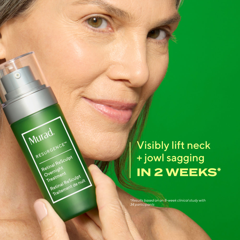 mature woman with bare face holding retinal resculpt overnight treatment