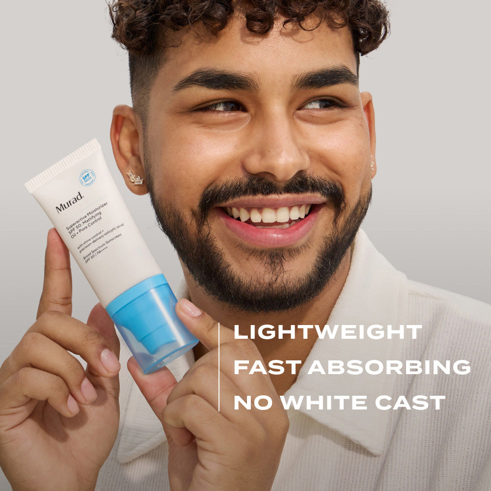 man smiling and holding Murad Supercharged Moisturizer SPF 50 mattifying