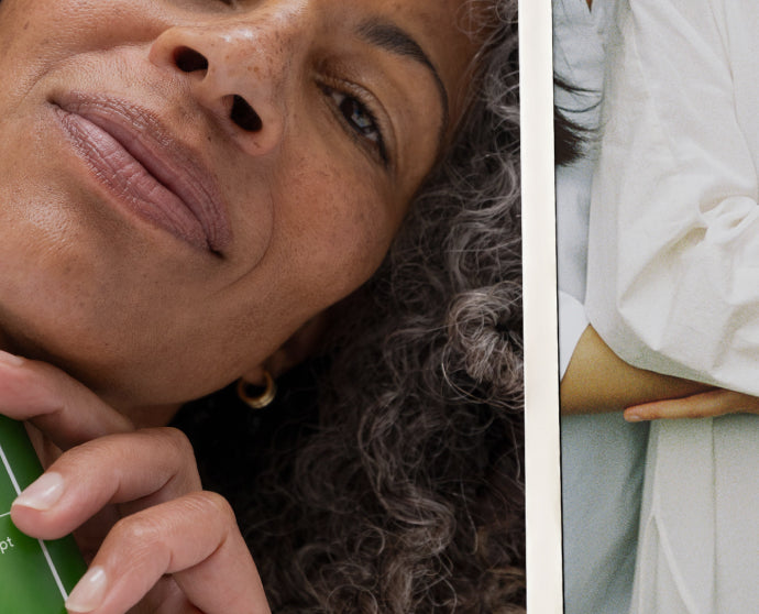 A close-up editorial-style photo split vertically: the left half shows part of a woman's face with curly gray hair holding a green object near her chin, and the right half shows another person in a white top from the chest up.